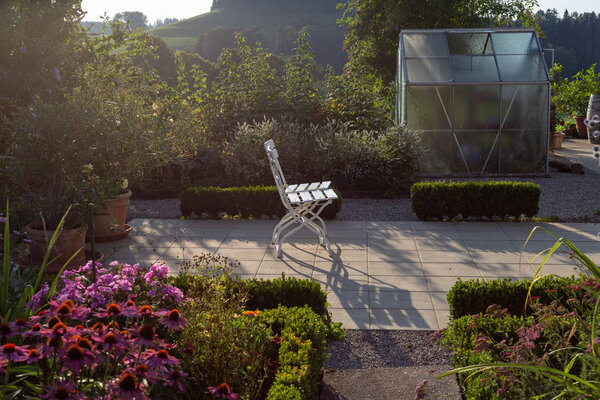 Cottage garden plastic shed on summer evening in Bavarian countryside