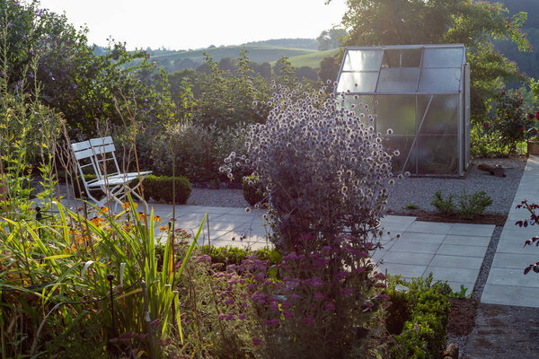 Cottage garden plastic shed on summer evening in Bavarian countryside