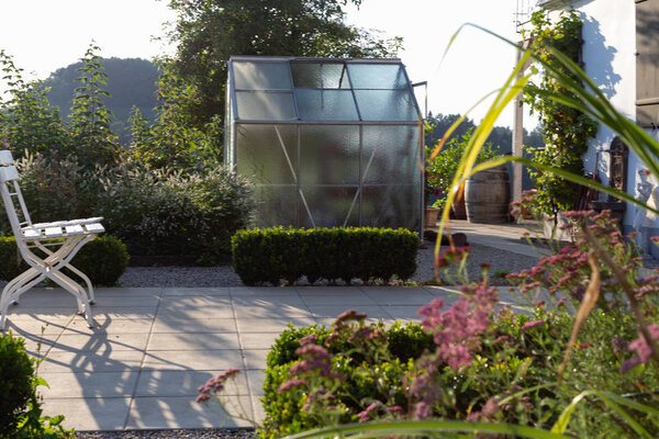 Cottage garden plastic shed on summer evening in Bavarian countryside