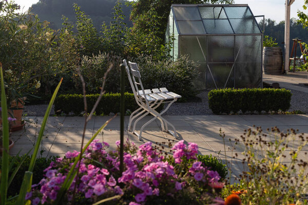 cottage garden plastic shed on a summer evening in south german bavaria countryside