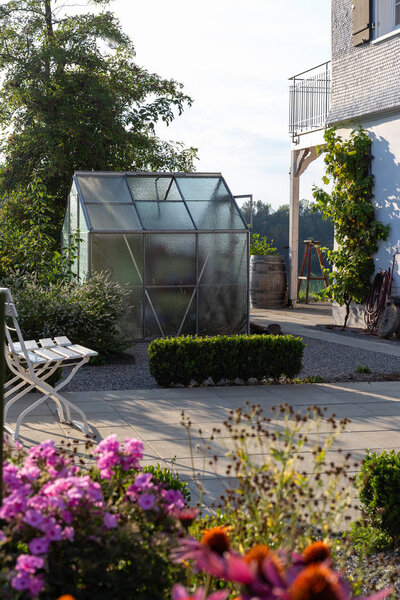 Cottage garden plastic shed on summer evening in Bavarian countryside