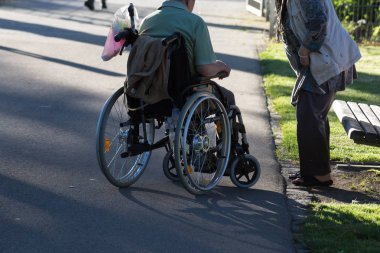 Haziran ayında bir şehir parkının Merkezi Güney Almanya'da bir akşam seni çift park veren gölge hareket tekerlekli sandalye ile görmek