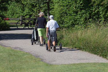 çok güneşli bir Haziran ayında Güney Almanya bayrakları ile yeşil ve oyuncular ve golf topu ile golf alanları görmek ve alan kum