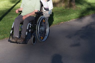 Haziran ayında bir şehir parkının Merkezi Güney Almanya'da bir akşam seni çift park veren gölge hareket tekerlekli sandalye ile görmek