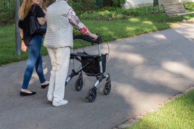 Haziran ayında Güney Almanya çok güneşli bir günde kıdemli rollator ile görmek ve şirket size iyi eğlenceler tarihi şehir parkında