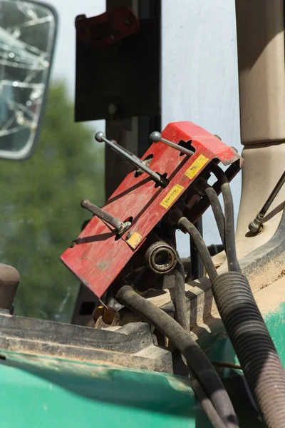 stock image on a sunny day in june in south germany in rural countryside you see machine, wheels and parts of farmhouse equipment for harvesting and agricultural work