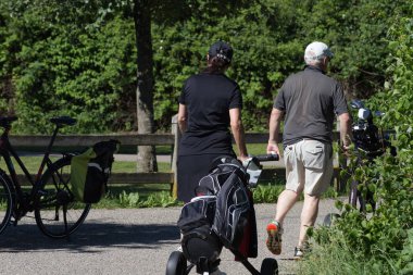 çok güneşli bir Haziran ayında Güney Almanya bayrakları ile yeşil ve oyuncular ve golf topu ile golf alanları görmek ve alan kum
