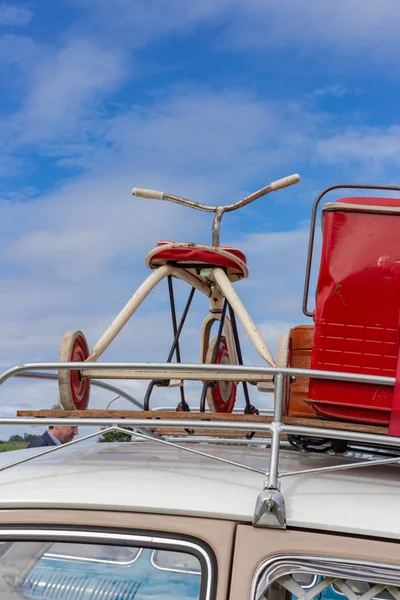 Travel case on roof with tricycle at countryside in southern Germany.