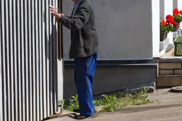 Senior man at farmhouse in countryside of southern Germany.