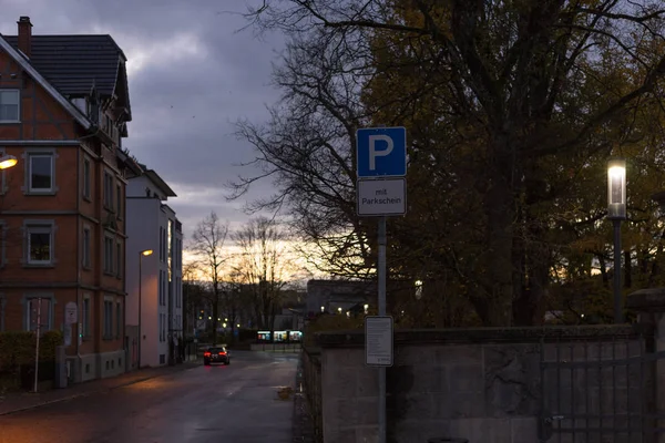 sunset city lights and symbols of a historical city like old tower and crucifix in south germany autumn november evening near city of stuttgart and munich