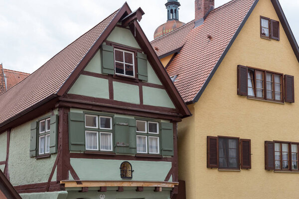 In a historical city of bavaria in south germany at summertime old wooden timber frame buildings with windows, doors and deecorations are a romantical place to have holiday of even relaxing time