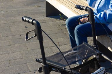 rollator and handles at a city park at springtime of south germany clipart