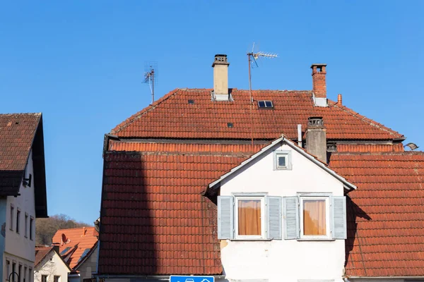 city facades rooftops antenna chimney in springtime evening in south germany