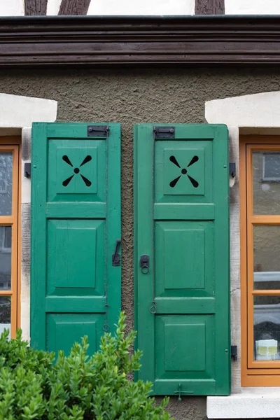 framework historical building facade with green window shutters in imperial city of south germany schwaebisch gmuend