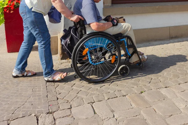 Senior couple with wheel chair in southern Germany.