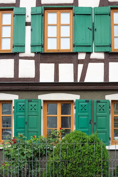 framework historical building facade with green window shutters in imperial city of south germany schwaebisch gmuend