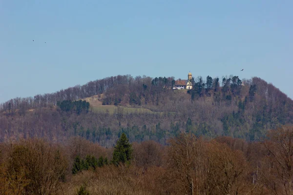 Central German Uplands on easter springtime holiday with blue sky and green fields forest trees