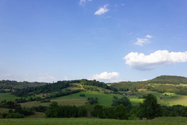 Bahar yeşil alanları mavi gökyüzü ve bulutlar bir dağlık güney Almanya kırsal kırsal manzara