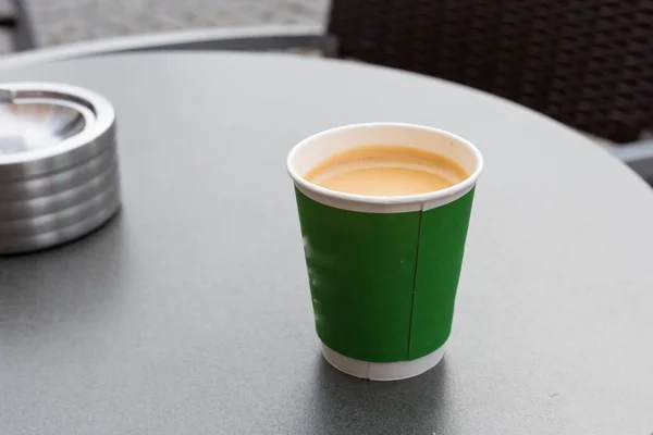 ashtray on a coffee to go table cup on a wonderful springtime holiday afternoon in south germany