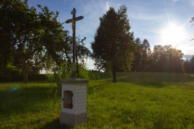 Haç ve başarısız bir gün batımı akşam güneş ışınları ve bulutlar allgau Bavyera kırsalında sunakta