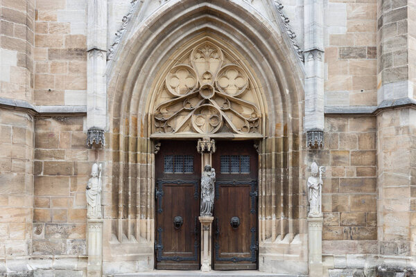 catholic church facade in south germany with brown and orange grey stone color and structure