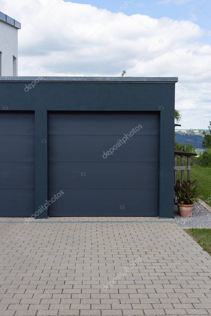 modern black garage in suburban street in south germany countryside near city stuttgart