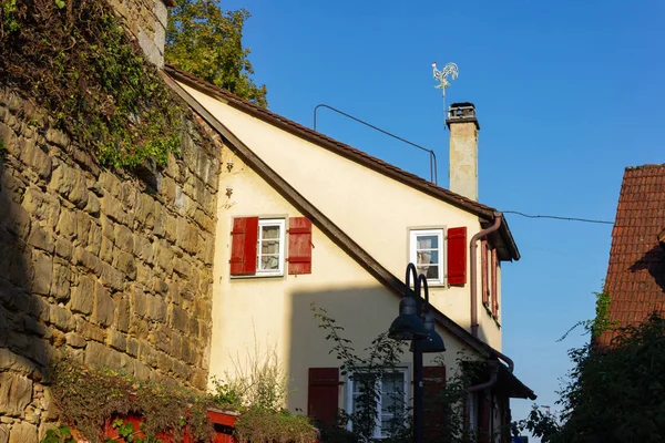 weathercock on rooftop of historical framework building in south germany