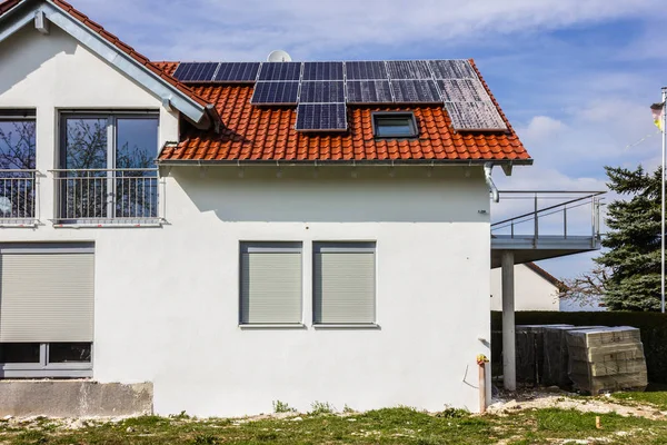 framing house with solar panels on rooftop at south german countryside april springtime afternoon