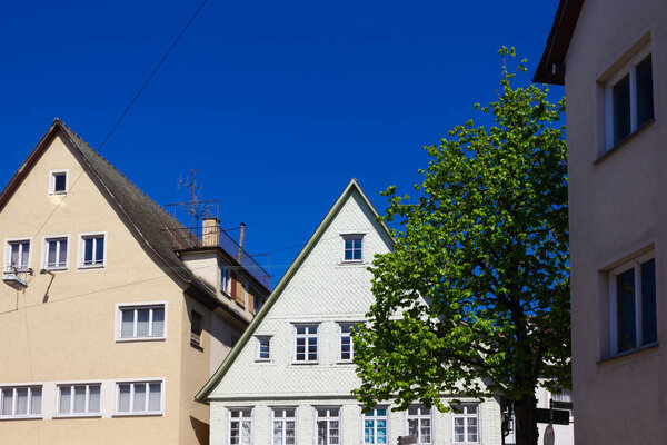 Historical house facades and rooftops on blue sky at springtime april in south germany