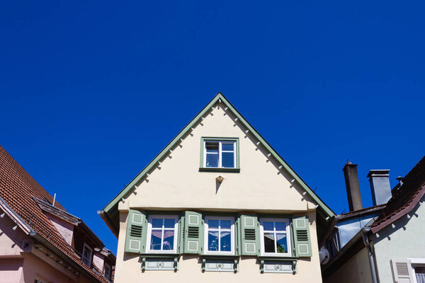 Historical house facades and rooftops on blue sky at springtime april in south germany