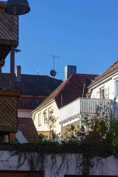 City house rooftops with chimney and antenna at april springtime in south germany