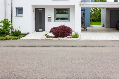 house entrance of new modern building in germany springtime clipart