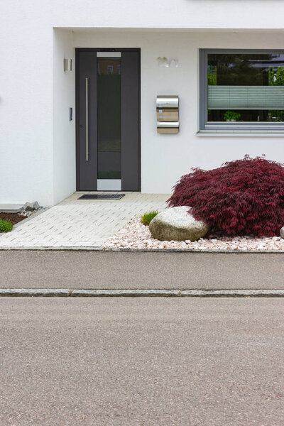 house entrance of new modern building in germany springtime