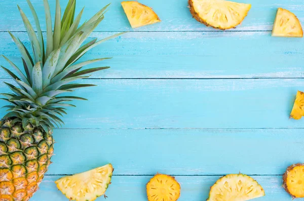 Tropikal ananas ahşap tahta mavi renk üzerinde. çerçeve düzeni yaz tatil arka plan kavramı.