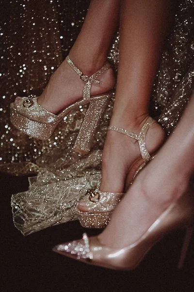 Blurred photo of  models legs  in gold shoes and dresses on backstage during FASHION WEEK