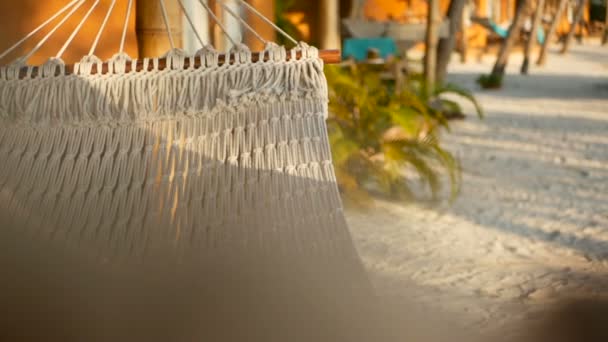 Close up of romantic cozy swinging hammock in a pleasant laziness of a weekend sunset. — Stock Video