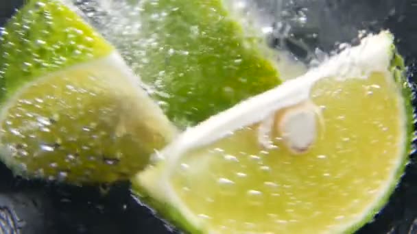 Detox or thirst concept. Healthy, dietary nutrition. Cold lemonade, lime drink. Black background — Stock Video