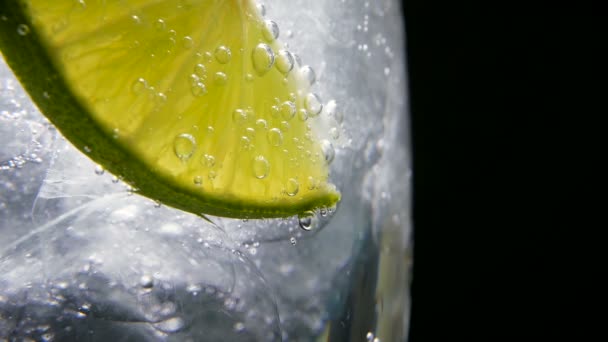 Detox or thirst concept. Healthy, dietary nutrition. Cold lemonade, lime drink. Black background — Stock Video