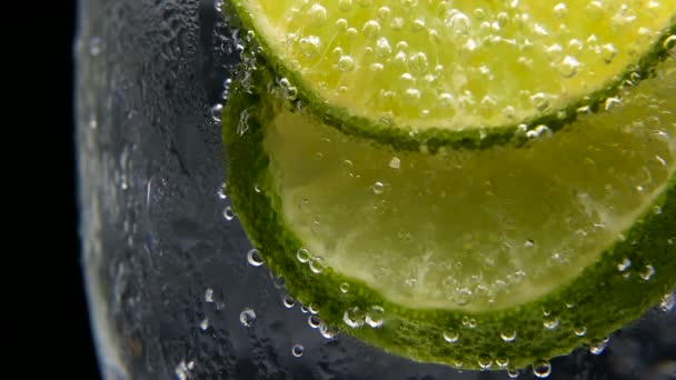 Detox or thirst concept. Healthy, dietary nutrition. Cold lemonade, lime drink. Black background — Stock Video