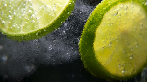 Detox or thirst concept. Healthy, dietary nutrition. Cold lemonade, lime drink. Black background — Stock Video