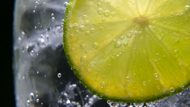 Detox or thirst concept. Healthy, dietary nutrition. Cold lemonade, lime drink. Black background — Stock Video