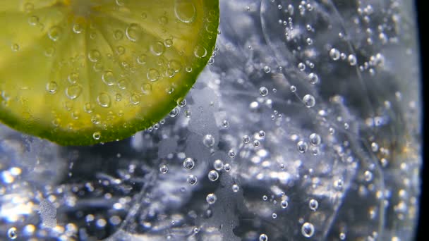 Detox or thirst concept. Healthy, dietary nutrition. Cold lemonade, lime drink. Black background — Stock Video