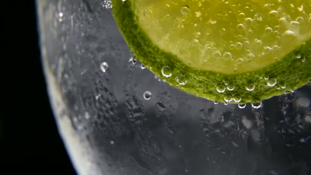 Detox or thirst concept. Healthy, dietary nutrition. Cold lemonade, lime drink. Black background — Stock Video