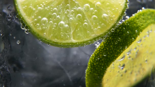 Detox or thirst concept. Healthy, dietary nutrition. Cold lemonade, lime drink. Black background — Stock Video