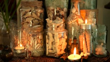 Deniz kabuklarını, mercanlar, deniz öğeleri mum ışıklı plumeria çiçekler, Buda dekorasyonu için oturma ile dolu cam şişe