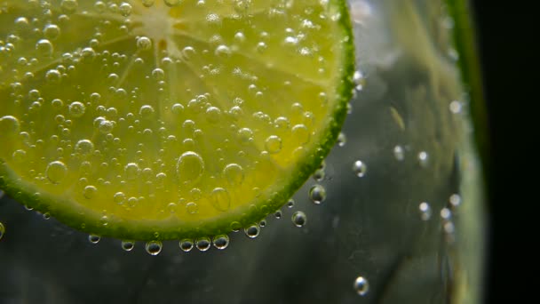 Detox or thirst concept. Healthy, dietary nutrition. Cold lemonade, lime drink. Black background — Stock Video