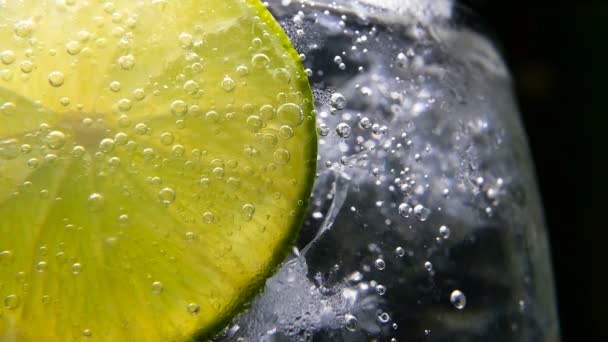 Detox or thirst concept. Healthy, dietary nutrition. Cold lemonade, lime drink. Black background — Stock Video