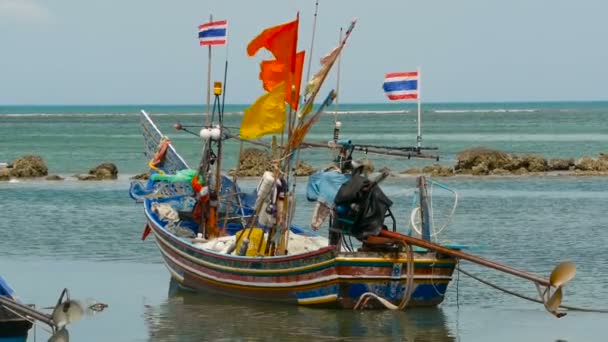 Tropical ocean beach, moored wooden traditional colorful fishing boat. Seascape near asian poor Muslim fisherman village — Stock Video