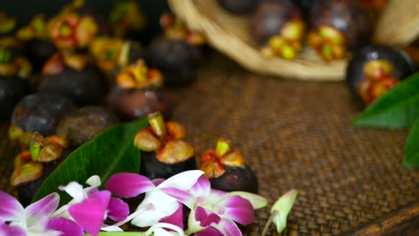 Vista superior de mangostanes frescos y deliciosos cosechados en mesa de madera. Fruta morada orgánica tailandesa en la cesta . — Vídeo de stock