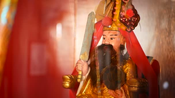 Buddhist traditional statues of chinese sacred gods on the altar inside the temple. — Stock Video